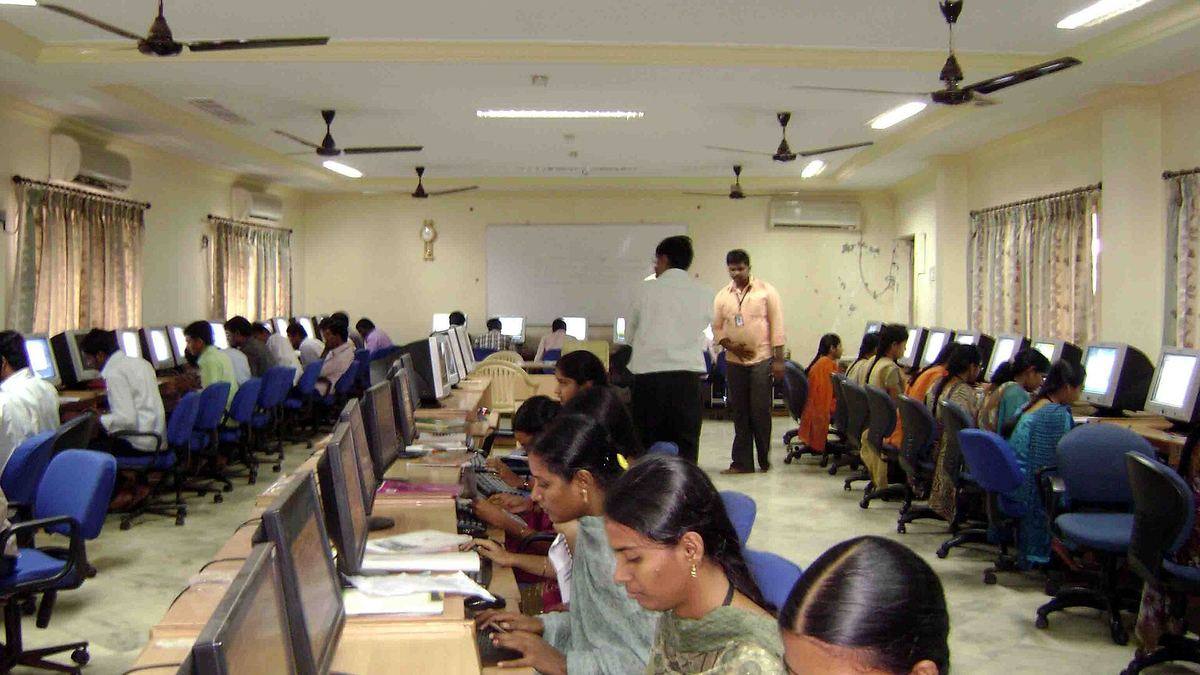 Students working at computers in a college computer lab in India