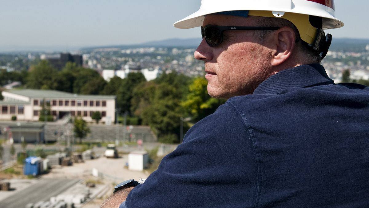 An engineer in a hard hat looking over a construction site