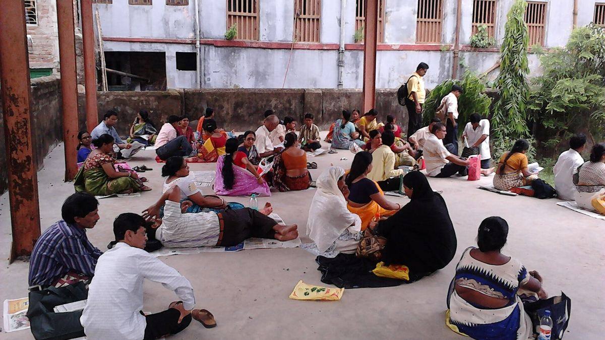 Candidates and parents waiting in the courtyard of an exam centre in Howrah, West Bengal